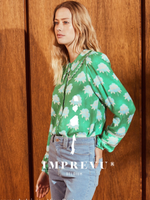 Green patterned top with blue flower
